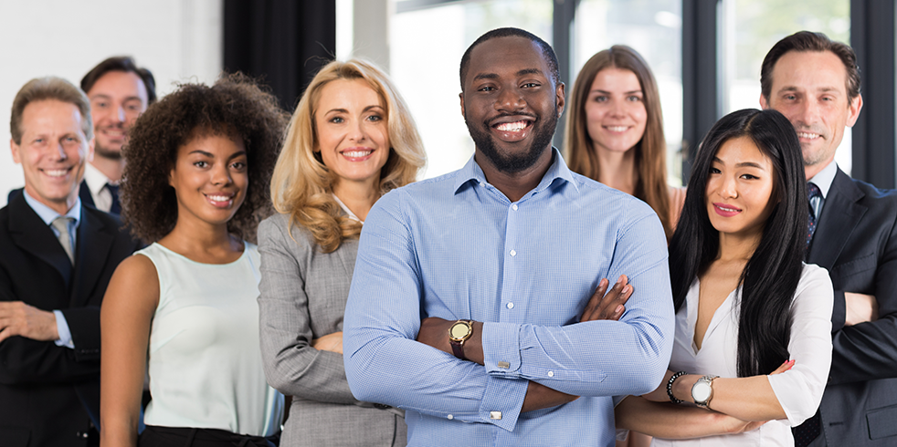 Group of young professionals smiling for photo.